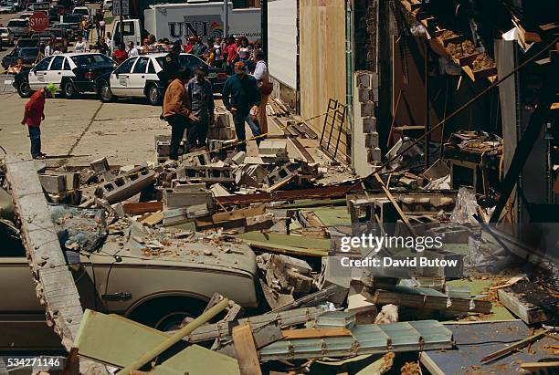 Debris covers a nearby sidewalk in the aftermath of the Oklahoma city bombing. On April 19 Timothy McVeigh exploded a truck bomb outside of the...