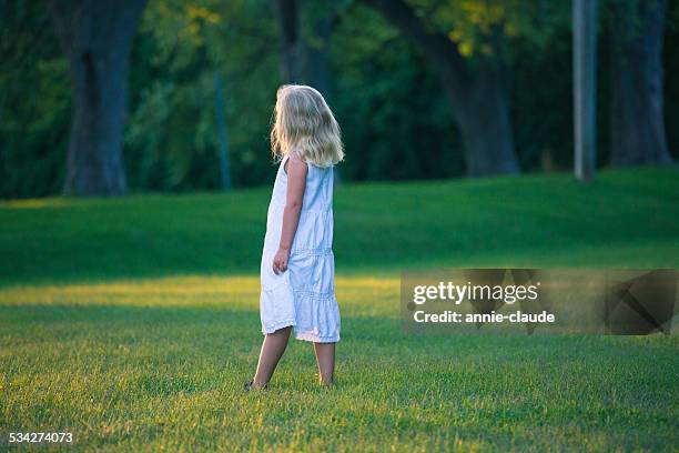 little girl standing in a park - white dress stock pictures, royalty-free photos & images
