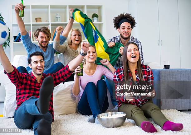 multiethnic group of friends watching a football game - beer bottle mouth stock pictures, royalty-free photos & images