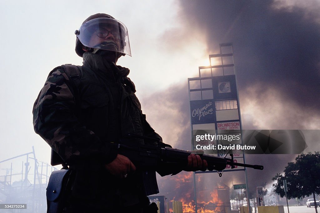 Guardsman Standing near Burning Building