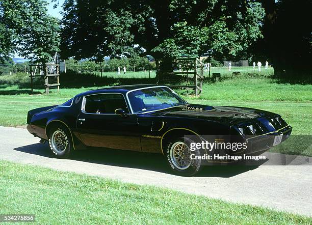 Pontiac Firebird trans am by cricket ground in UK, 2000.