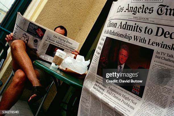 People in a California coffee shop read the Los Angeles Times the day after President Bill Clinton admitted to having a relationship with Monica...