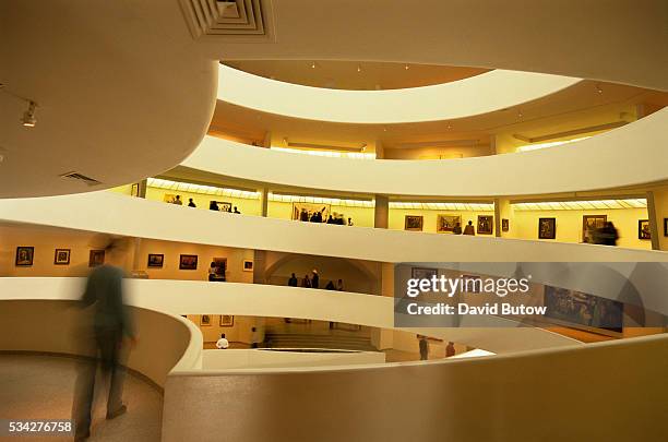 Museum visitors walk through the Solomon R. Guggenheim Museum in New York City. The unique architecture was designed by architect Frank Lloyd Wright.