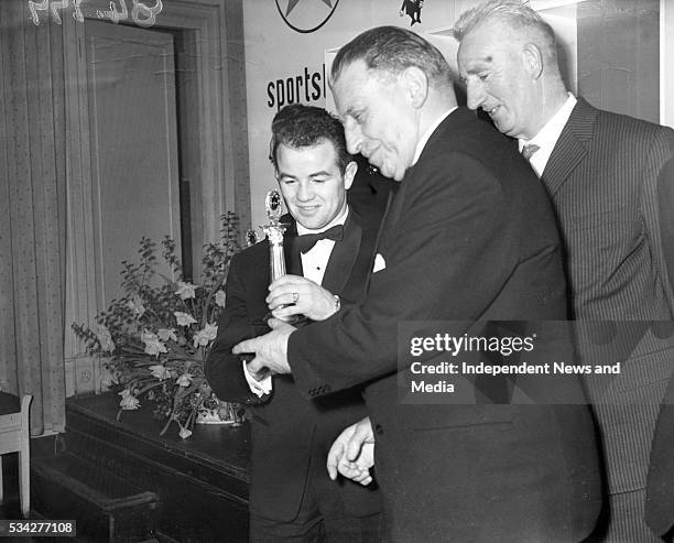 Caltex Award winner for boxing 1962 Freddie Gilroy receiving his trophy from Mr Sean Lemass at the Gresham Hotel. R3759 .