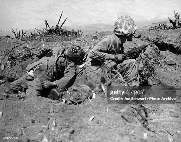 Marine Crouches Near Corpse of Japanese Officer