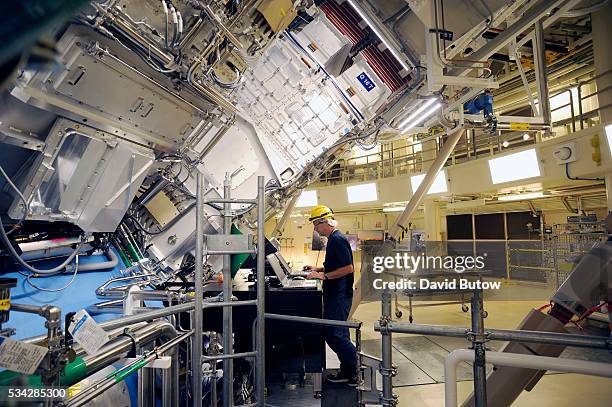Engineers work outside the structure where the array of lasers at the National Ignition Facility at Lawrence Livermore Laboratory are focused. The...
