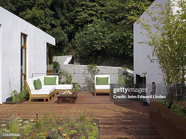 seating area in front of fireplace on deck - garden decking stock-fotos und bilder