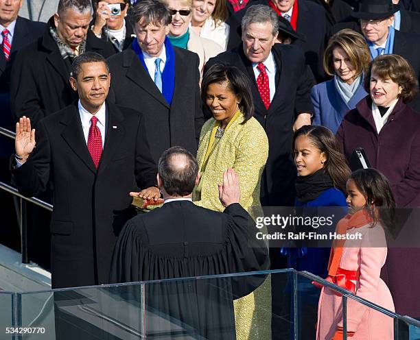 President-Elect Barack Obama is sworn in by Chief Justice John Roberts as the 44th President of the United States.