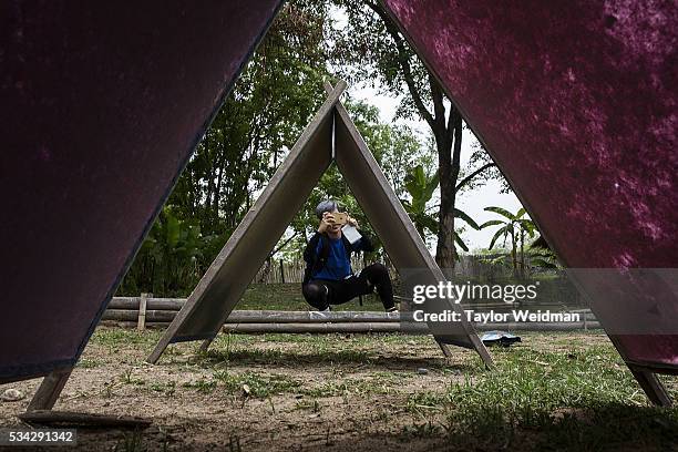 Chinese tourist photographs drying elephant dung paper at Elephant "PooPooPaper" Park on May 24, 2016 in Mae Rim, Thailand. Elephant "PooPooPaper"...