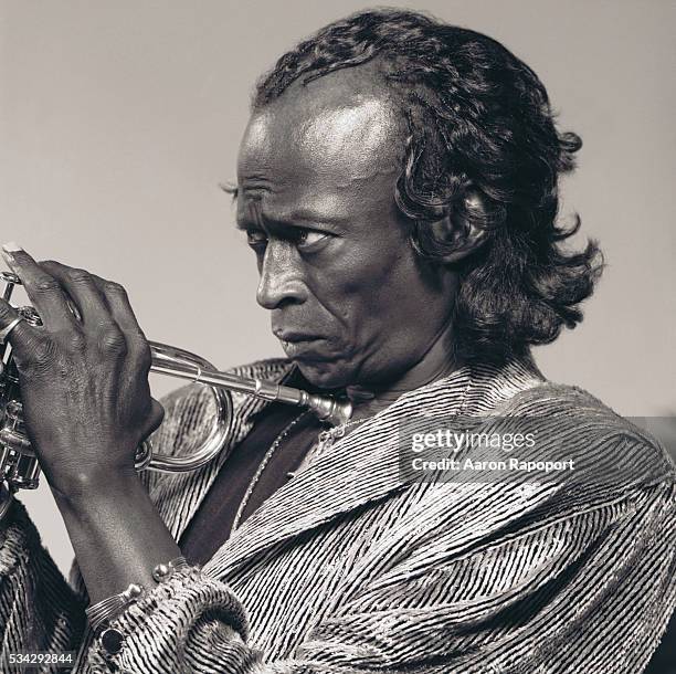 Miles Davis holding a trumpet
