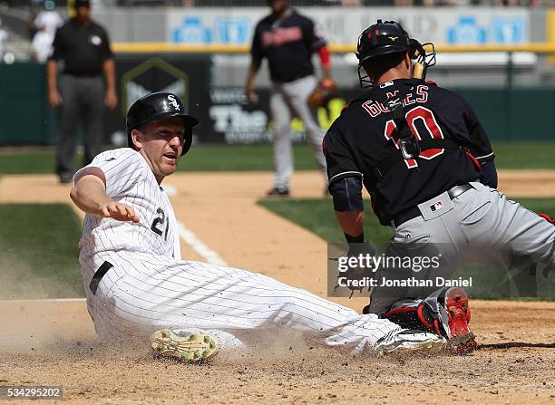 Todd Frazier of the Chicago White Sox slides in to score a run past Yan Gomes of the Cleveland Indians on a fielding error in the 6th inning at U.S....