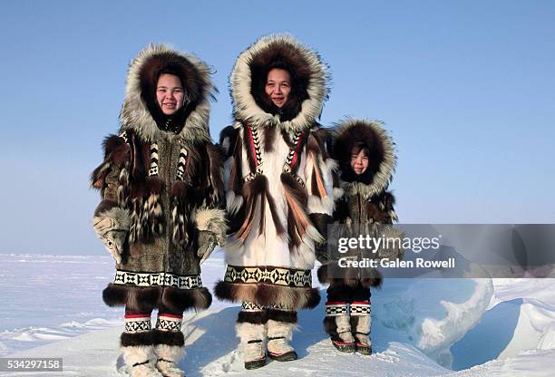 inuit woman and children in winter furs - inuit stock pictures, royalty-free photos & images