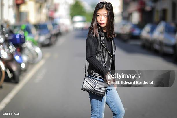 May Berthelot , is wearing an Iro sleeveless black leather jacket, The Kooples blue jeans, Zara black leather boots, a Chanel cachemire black body...