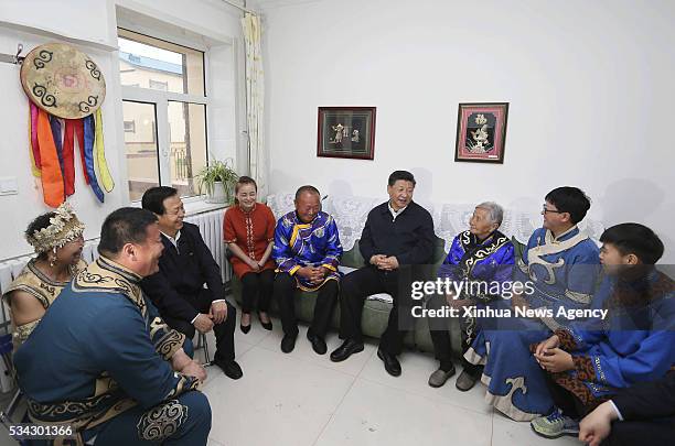 May 25, 2016 -- Chinese President Xi Jinping pays a visit to the home of villager You Guilan, third right, in the Bacha Village of Bacha Hezhe...