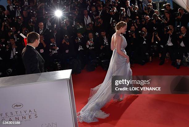 Romanian director Cristian Mungiu and Romanian actress Maria Dragus leave a photocall after he was awarded with the Best Director prize for the film...