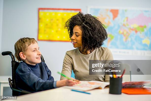 boy with disability - disability carer stock pictures, royalty-free photos & images