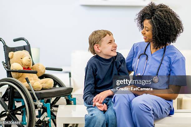 boy with developmental disability - teenager cerebral palsy stock pictures, royalty-free photos & images