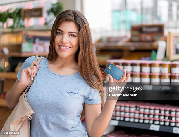 woman at the supermarket paying by card - loyalty cards stock pictures, royalty-free photos & images