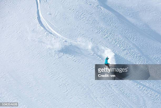 skier skiing off-piste on a beatiful mountain slope - skigebied stockfoto's en -beelden