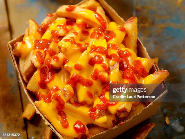 cheese fries with chilli sauce - cheesy fries stock pictures, royalty-free photos & images