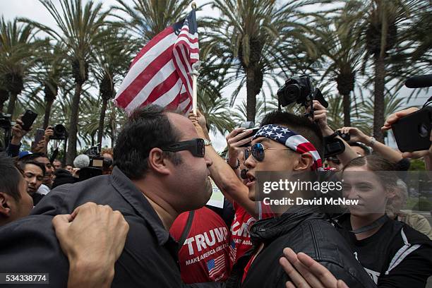 An anti-Trump protester and a Trump support clash outside a campaign rally by presumptive GOP presidential candidate Donald Trump at the Anaheim...