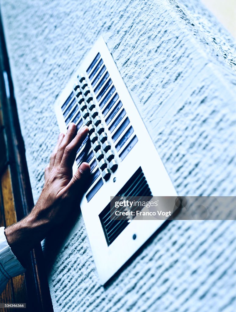 Pushing Button on Building Intercom