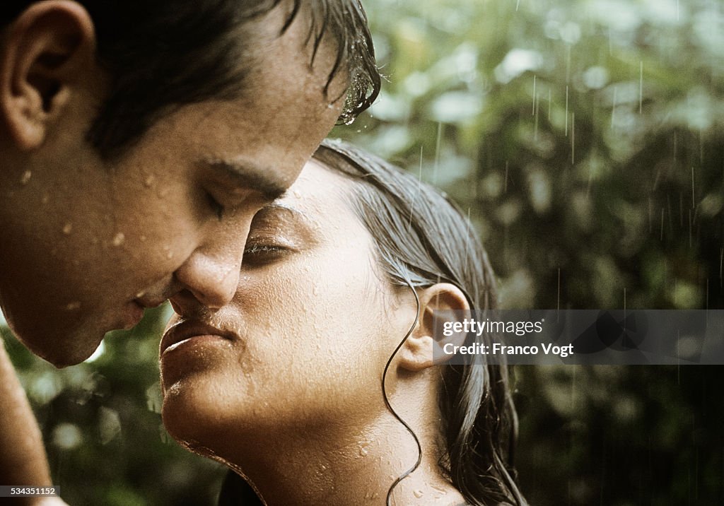 Man and Woman Kissing in Rain
