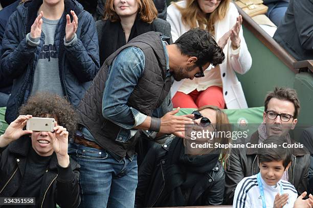 Maxime Nucci and Isabelle Ithurburu at Roland Garros on May 24, 2016 in Paris, France.