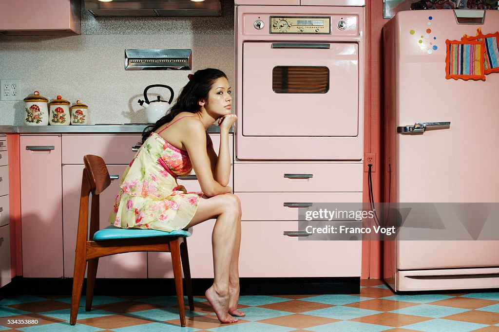 Bored Woman Sitting in Kitchen