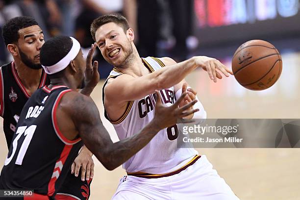 Matthew Dellavedova of the Cleveland Cavaliers passes in the second quarter against Terrence Ross of the Toronto Raptors in game five of the Eastern...