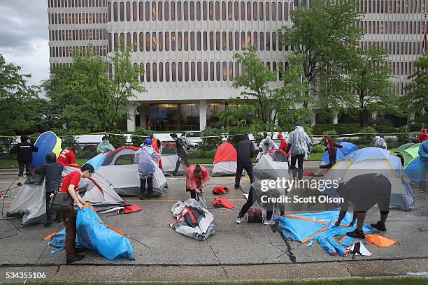 Demonstrators calling for an increase in the minimum wage to $15-dollars-per-hour pitch tents for an overnight protest outside of McDonald's...