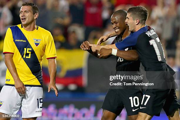 Pedro Larrea of Ecuador reacts as Nagbe Darlington of the United States celebrates with Christian Pulisic of the United States after scoring against...