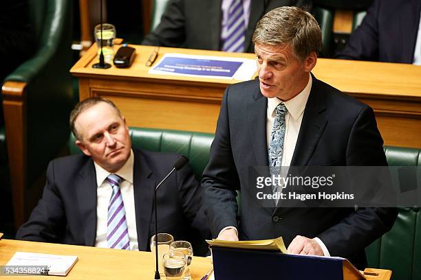 Finance Minister Bill English speaks while Prime Minister John Key looks on during the 2016 budget presentation at Parliament on May 26, 2016 in...