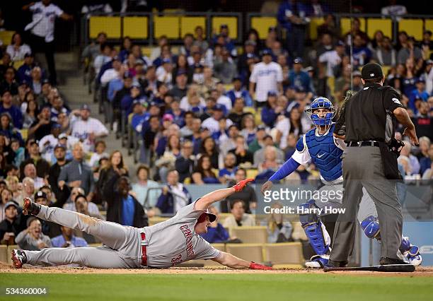 Jay Bruce of the Cincinnati Reds reacts after being tagged out by Yasmani Grandal of the Los Angeles Dodgers attempting to sttretch an RBI triple...