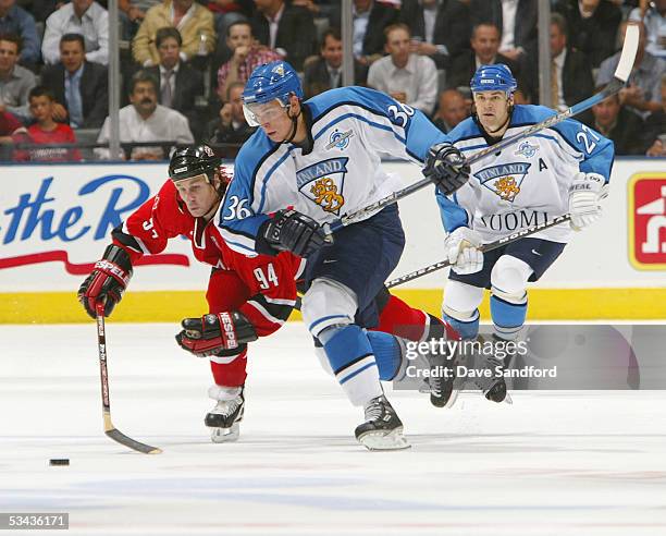 Riku Hahl of Finland and Ryan Smyth of Team Canada chase the puck during the 2004 World Cup of Hockey Championship game on September 14, 2004 at the...