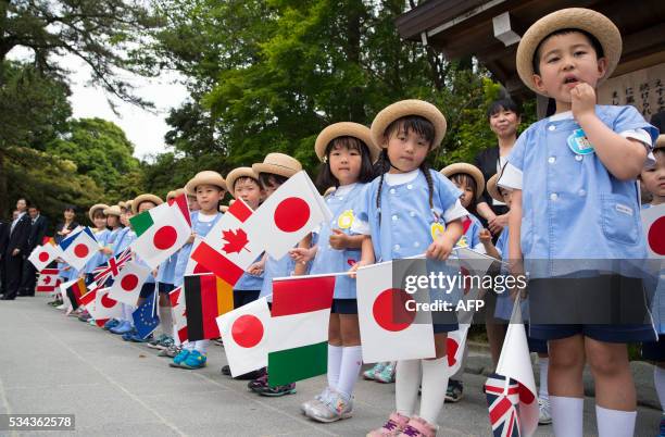 Group of school children wait for the G7 leaders to arrive for their tour of the Ise-Jingu Shrine in the city of Ise in Mie prefecture, on May 26,...