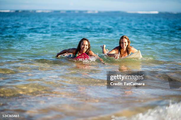 mother and daughter returns from surfing the break - hawaii vacation and parent and teenager stock pictures, royalty-free photos & images