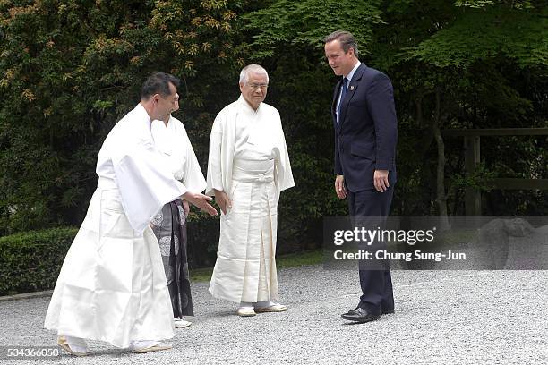 British Prime Minister David Cameron is greet by Shinto priests as he visit the Ise-Jingu Shrine on May 26, 2016 in Ise, Japan. In the two-day...