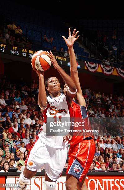 Taj McWilliams-Franklin of the Connecticut Sun goes to the basket against Tammy Sutton-Brown of the Charlotte Sting during the game at Mohegan Sun on...