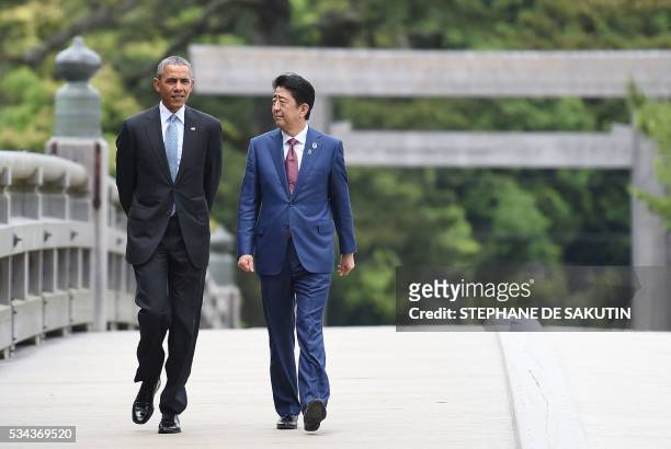 President Barack Obama walks with Japan's Prime Minister Shinzo Abe as they arrive at Ise-Jingu Shrine in the city of Ise in Mie prefecture, on May...