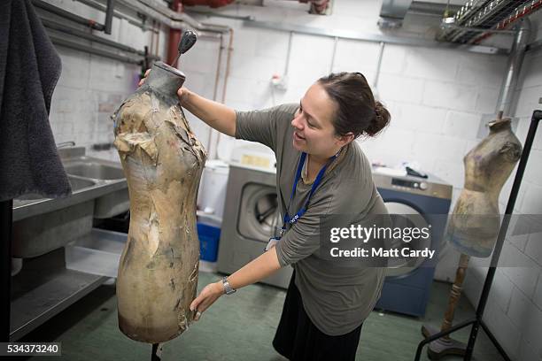 Wardrobe supervisor Emma Cains adjusts a mannequin backstage at the Bristol Old Vic, on May 24, 2016 in Bristol, England. The Bristol Old Vic, which...