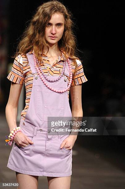 Model walks down the runway during the Mercearia fashion presentation during the Pre-a-Porter fashion exhibition at Joquei Club on August 11, 2005 in...