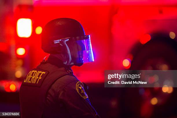 Sheriffs deputy in riot gear advance to make possible mass arrests after declaring an unlawful assembly following a campaign rally by presumptive GOP...