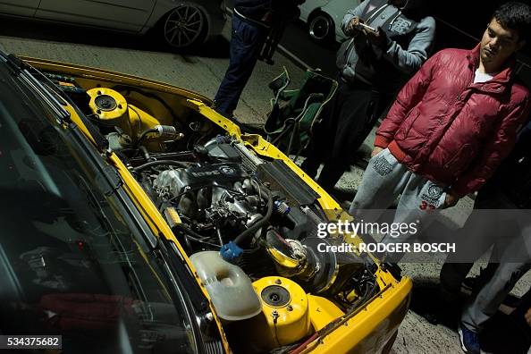 Robot Racing Explosed A man looks at an exposed engine during a 'Robot Racing' -robots is a ...