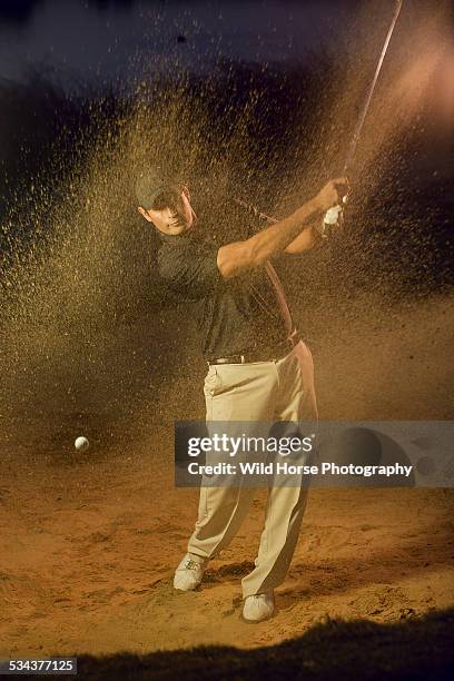 golfer chipping from sand trap - バンカーショット ストックフォトと画像