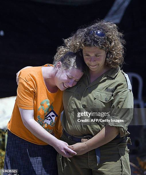 An Israeli settler is comforted by a soldier as she is led away from a house in the Southern Gaza Strip Gush Katif settlement of Gadid 19 August...