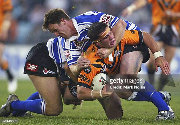 Chris Heighington of the Tigers is tackled during the round 24 NRL match between Wests Tigers and the Bulldogs at Telstra Stadium on August 19, 2005...