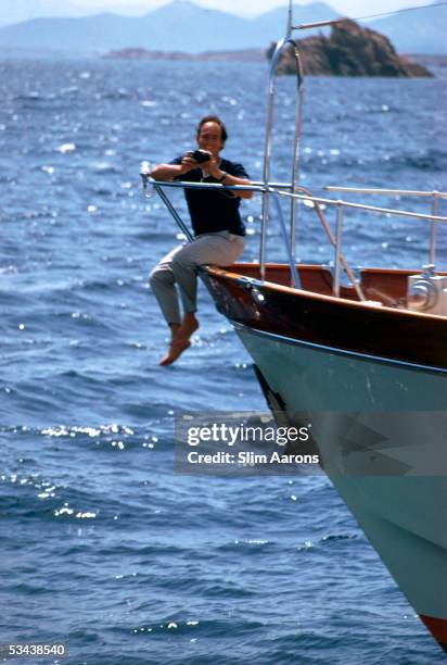 Prince Karim Aga Khan perches on the prow of his yacht on the Costa Smeralda, Sardinia, 1967.