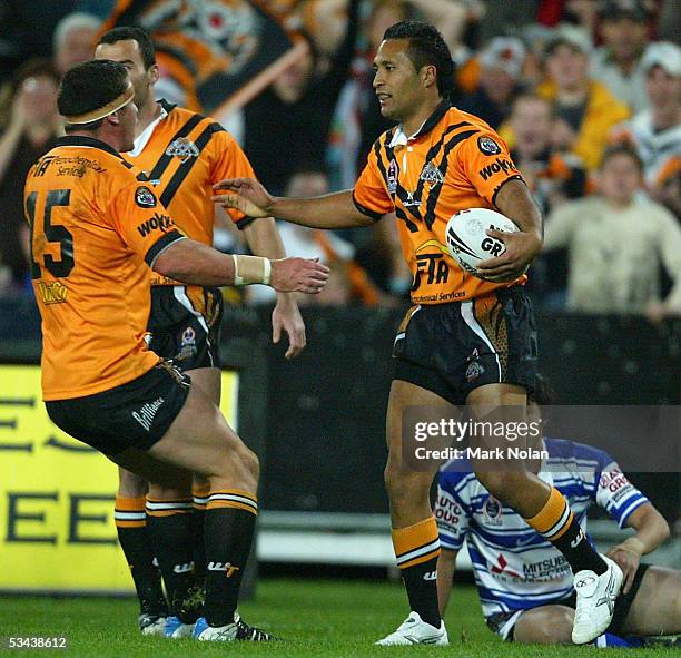 Paul Whatuira of the Tigers after scoring during the round 24 NRL match between Wests Tigers and the Bulldogs at Telstra Stadium on August 19, 2005...