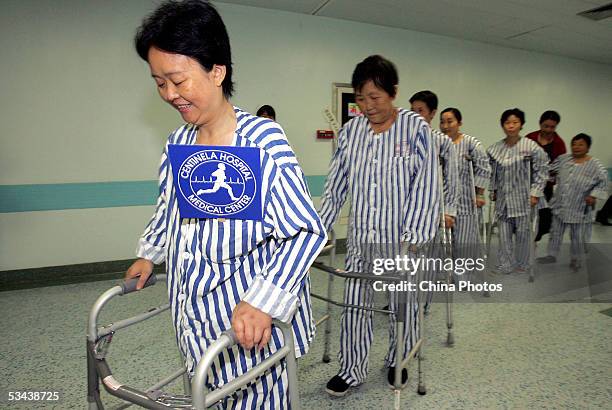 Patients suffering from bone diseases, walk with supports after undergoing joint replacement surgeries at the West China Hospital of Sichuan...